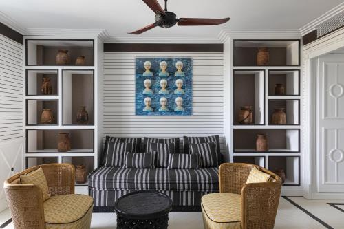 a living room with a couch and a ceiling fan at Savoy Hotel & Spa - Preferred Hotels & Resorts in Paestum