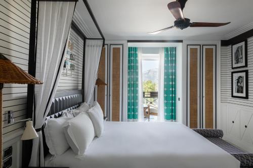 a bedroom with a white bed and a window at Savoy Hotel & Spa - Preferred Hotels & Resorts in Paestum