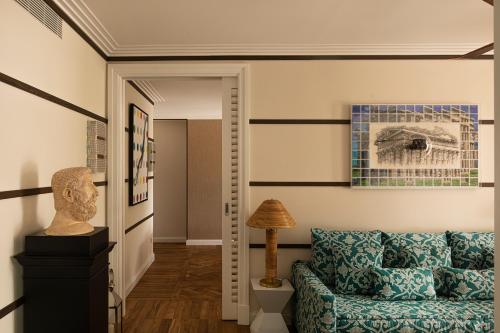 a living room with a couch and a lamp at Savoy Hotel & Spa - Preferred Hotels & Resorts in Paestum