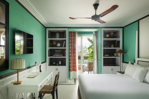 a bedroom with a bed and a desk and a table at Savoy Hotel & Spa - Preferred Hotels & Resorts in Paestum