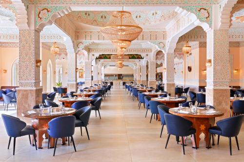 a row of tables and chairs in a restaurant at Pickalbatros Aqua Park Sharm El Sheikh in Sharm El Sheikh