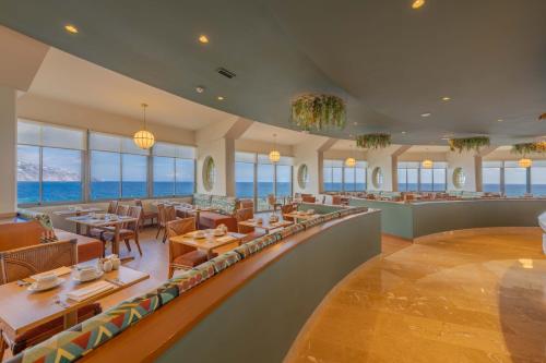 a restaurant with a view of the ocean at Pestana Vila Lido Madeira Ocean Hotel in Funchal