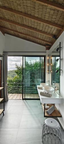 a bathroom with two sinks and a large window at Villa on the Rock - Luxury, Privacy, Pool, Sea View in Koh Phangan in Thong Sala
