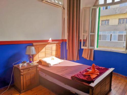 a bedroom with a large bed with a window at Cairo Lodge Hostel in Cairo