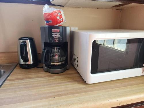 a coffee maker and a microwave on a counter at Urban Getaway on 7th in Niagara Falls