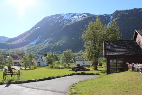 a small village with a mountain in the background at Skysstasjonen Cottages in Røldal