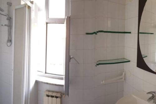 a bathroom with a shower with a window and a sink at Casa Aurelia in Rome