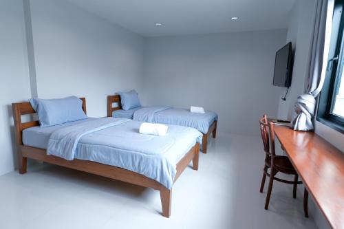 Ένα ή περισσότερα κρεβάτια σε δωμάτιο στο ChomTique Hotel