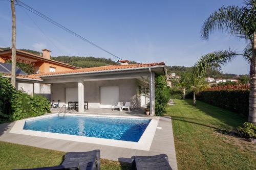 a swimming pool in the backyard of a house at Casa Natalia in Vila Nova de Famalicão
