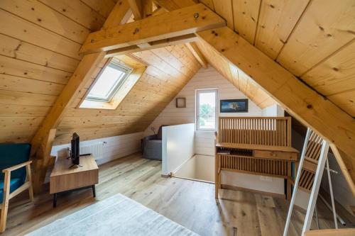 a cabin with a loft with a desk and a ladder at Havre de paix proche de la mer, pointe de Pors Pin in Plouézec