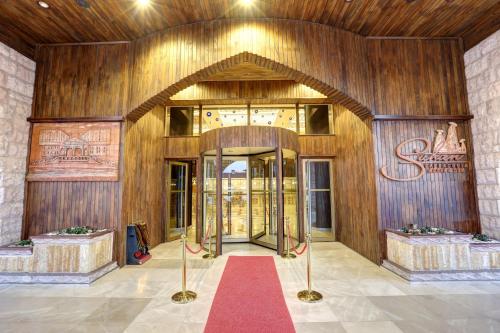 an entrance to a building with a red carpet at Suhan Cappadocia Hotel & Spa in Avanos
