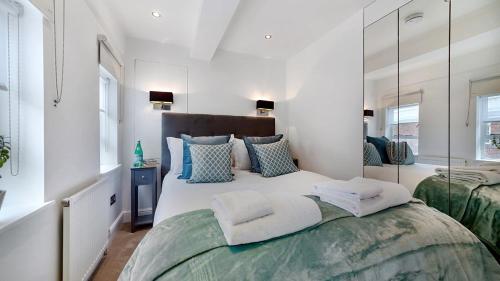 a bedroom with a large bed with a large mirror at Nell Gwynn Chelsea Accommodation in London