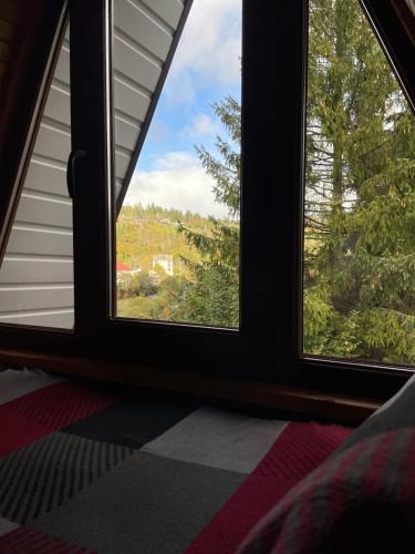 a room with two windows looking out at a view at Lavender House in Slavske