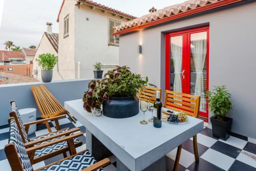 a patio with a table and chairs on a balcony at Danae Hotel in Nafplio