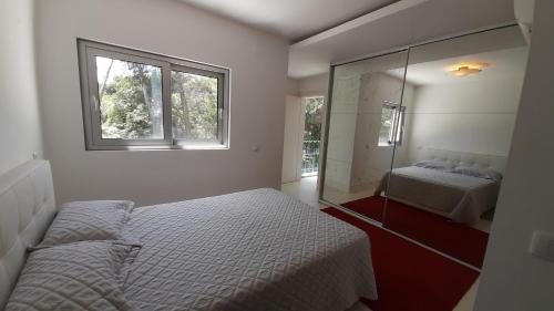 a bedroom with two beds and a mirror at Forest View in Lisbon