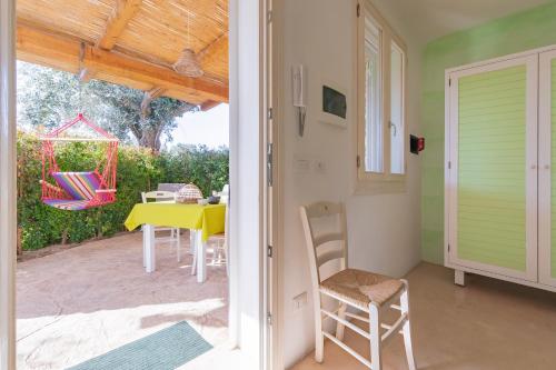 a dining room with a yellow table and chairs at Cava Li Santi Residence in Nardò