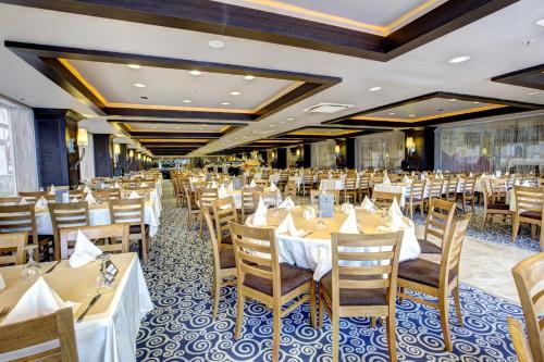 a banquet hall with tables and chairs in a restaurant at Suhan Cappadocia Hotel & Spa in Avanos