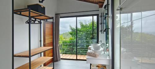 a room with a glass door leading to a balcony at Villa on the Rock - Luxury, Privacy, Pool, Sea View in Koh Phangan in Thong Sala