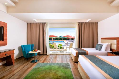 a hotel room with two beds and a balcony at Pickalbatros Aqua Park Sharm El Sheikh in Sharm El Sheikh