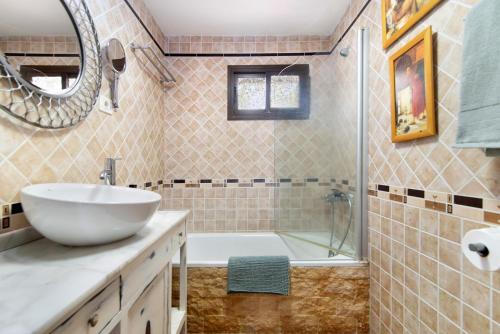 a bathroom with a sink and a shower and a tub at Villa Floti con vistas al mar in Telde