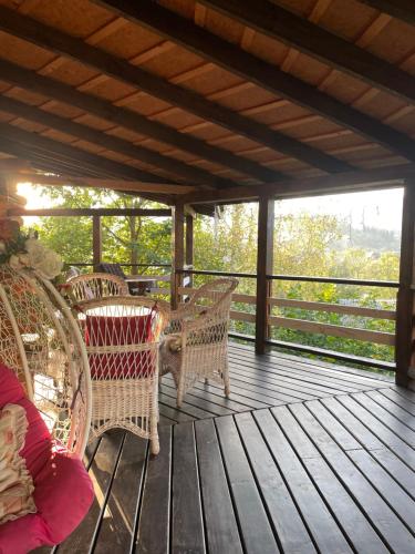 a porch with wicker chairs on a wooden deck at Lavender House in Slavske