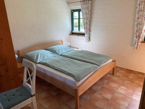 a small bed in a room with a window at Ferienhaus Mangels in Steinau