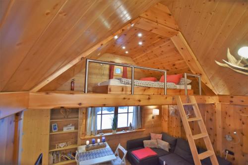 a loft bed in a tree house at Zirbenwald Chalet in Turracher Hohe