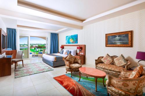 a hotel room with a bed and a living room at Pickalbatros Aqua Park Sharm El Sheikh in Sharm El Sheikh