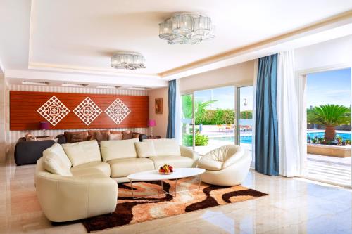 a living room with a couch and a table at Pickalbatros Aqua Park Sharm El Sheikh in Sharm El Sheikh