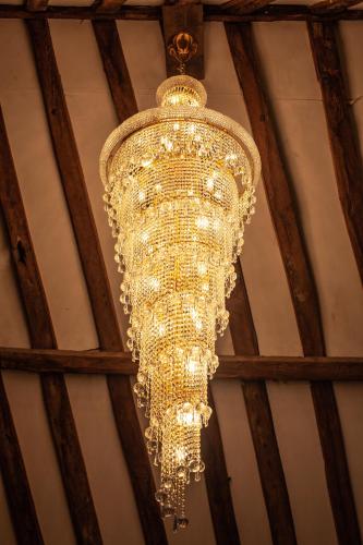 a large chandelier hanging from a ceiling at Best Western Brome Grange Hotel in Brome