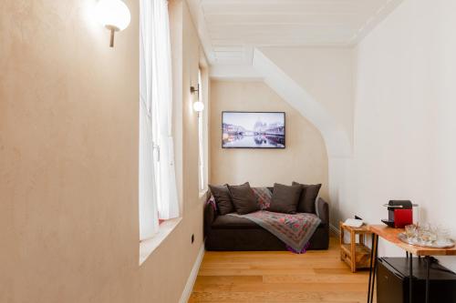 a living room with a couch and a window at Danae Hotel in Nafplio
