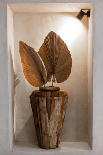 a wooden vase with a fan on top of it at Danae Hotel in Nafplio
