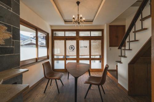 a dining room with a table and chairs at 城下の宿　燈 in Ōzu