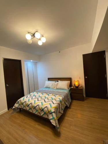 a bedroom with a bed and a ceiling fan at ABREEZA PLACE ONE BEDROOM SUITE (skyspot) in Davao City