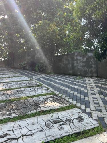 a beam of sunlight shining on a cobblestone patio at Hideaway Homestay kandy in Haloluwa