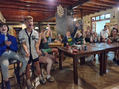 a group of people sitting at tables in a room at Imbabali Retreat & Venue in Magaliesburg