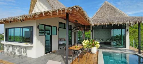 a villa with a patio and a swimming pool at Villa on the Rock - Luxury, Privacy, Pool, Sea View in Koh Phangan in Thong Sala