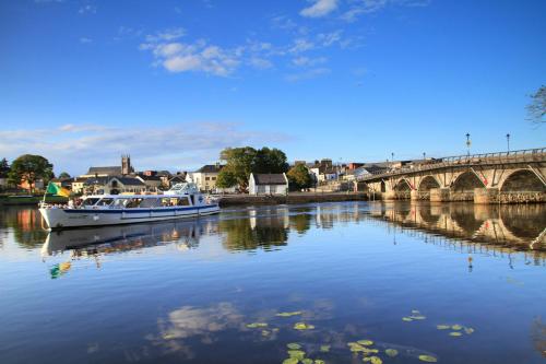 a boat on the water near a bridge at Rowing club house in Carrick on Shannon