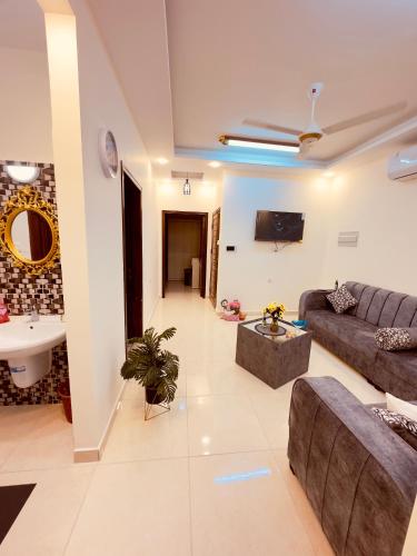 a large living room with a couch and a sink at ENG-Murjan Apartment in Aqaba