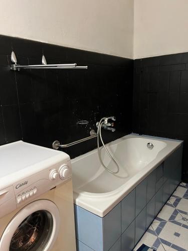 a bathroom with a washing machine and a washer at Room in Old Town Krakow in Kraków