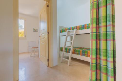 a bedroom with a bunk bed and a ladder at Cava Li Santi Residence in Nardò