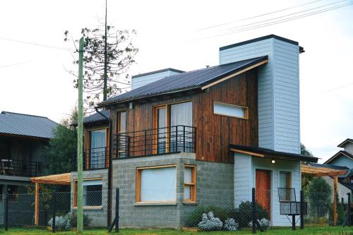 a house with a wooden facade at Origen Rent a house in El Bolsón