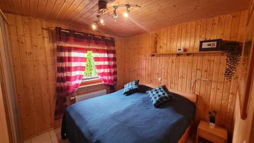 1 dormitorio con 1 cama en una habitación de madera en Ferienhaus-Burg en Celle