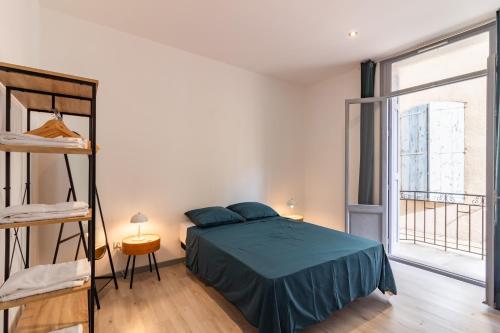 una camera da letto con un letto e una grande finestra di Appartement moderne et élégant quartier Saint-Jean Perpignan 2 a Perpignano