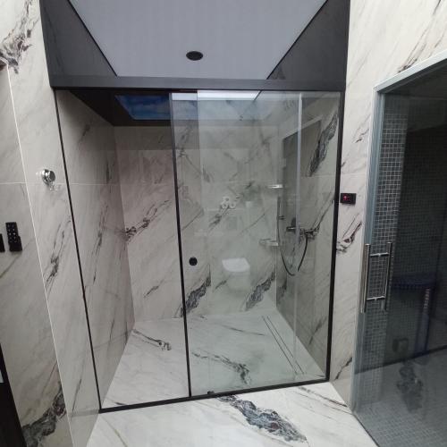a shower with a glass door in a bathroom at Apartament w Tucholi in Tuchola