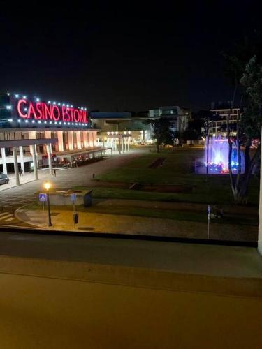 a view of a building with a casino sign at night at Estoril Terrace in Estoril