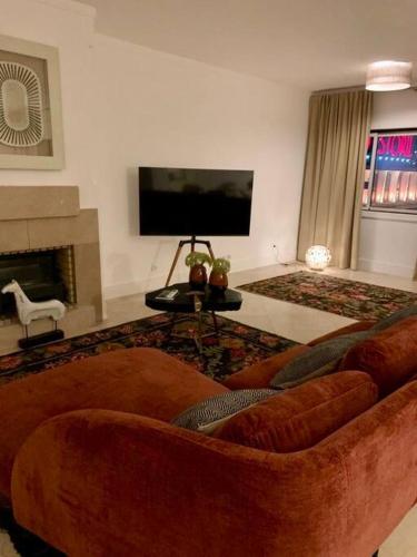 a living room with a couch and a fireplace at Estoril Terrace in Estoril