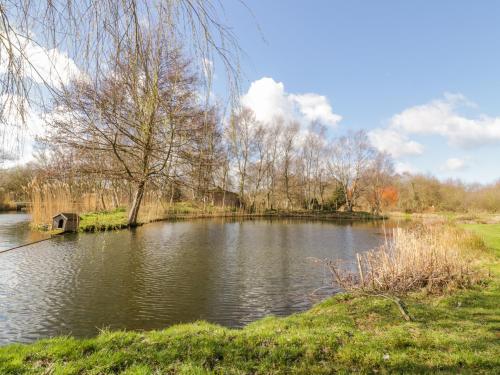 a lake with a boat in the middle of it at Brimstone in Norwich