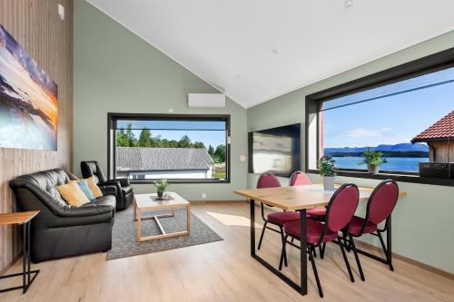 a living room with a table and chairs at Kviltorp Camping in Molde