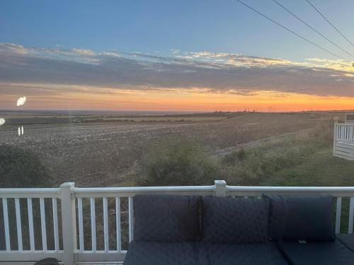 a view of the ocean from a porch with a couch at Seaview in Leysdown-on-Sea